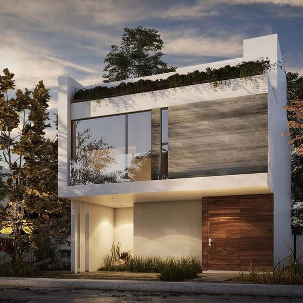 Fachada de la casa al atardecer, con muro de piedra texturizada, puerta de madera y luz cálida saliendo del interior.
